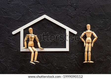 Family concept. Couple of wooden figures in house