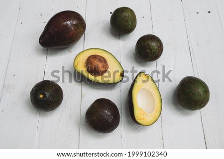 Avocados whole on  wooden  table background with copyspace