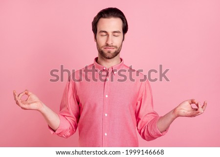 Photo of calm peaceful young man make fingers om sign asana rest isolated on pastel pink color background