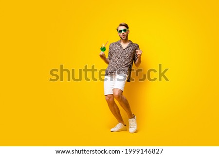 Full length photo of sweet attractive young gentleman dressed print shirt glasses drinking cocktail isolated yellow color background