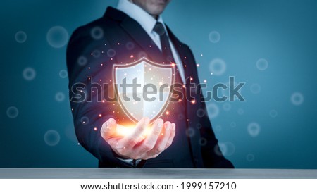 Businessman holding shield protect icon for internet firewall, insurance, or computer virus cleaner. Concept cyber security safe your data. Royalty-Free Stock Photo #1999157210