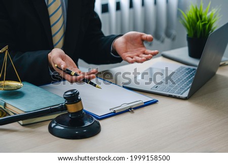 A lawyer or judge provides legal advice to clients in an attorney's office. legal advisor Scales of Justice, Law Hammer, Litigation and Justice Royalty-Free Stock Photo #1999158500