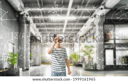 Little boy with VR glasses studying exact mathematical sciences Royalty-Free Stock Photo #1999161965