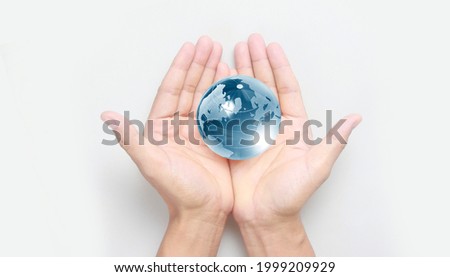 Glass globe in hand,Energy saving concept, Elements of this image furnished by NASA