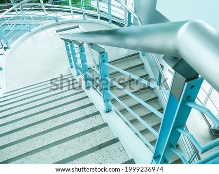 a stair with terrazzo floor and aluminium railing