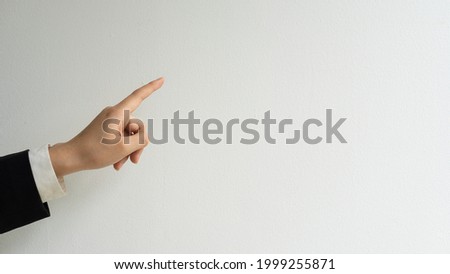 A woman's hand pointing to a white board that can insert text by herself.