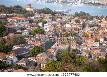 Close up view on the roofs of Gulangyu Island, Xiamen, Fujian, China. UNESCO World Heritage site. Wallpaper, background, copy space for text. Orange, green and blue colors 