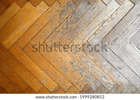 High-resolution photo of a transition of wooden tiles from a parquet floor in good condition to bad condition.
Seen from above. Lit from right. Old house, weather damage on wood. Royalty-Free Stock Photo #1999280852