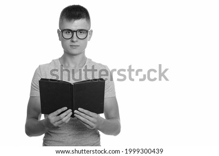 Studio shot of young handsome man with blond hair isolated against white background in black and white