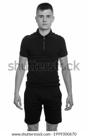 Studio shot of young handsome man with blond hair isolated against white background in black and white