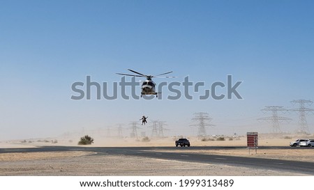 Police helicopter in the desert. Police training and rescue operation concept. Royalty-Free Stock Photo #1999313489