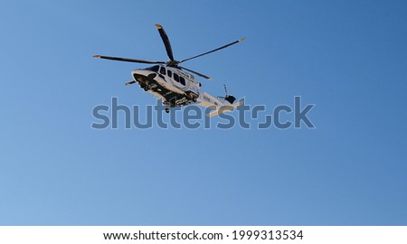 Police helicopter in the desert. Police training and rescue operation concept. Royalty-Free Stock Photo #1999313534