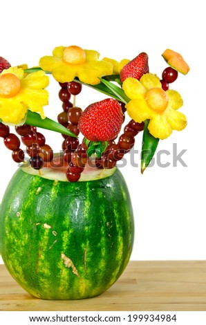 pineapple, grapes and strawberry bouquet in watermelon on a butcher block