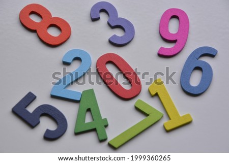 shot of a group of numbers made of wood scattered on the white table