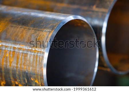 Close up photo of two rusted pipes with new facets after machining. Prepared to connect by welding. Low depth-of-field.