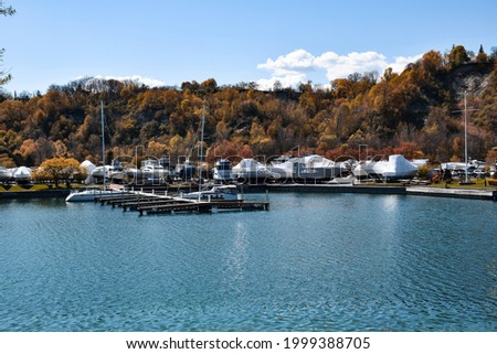Parked boats at a marina covered for the off season Royalty-Free Stock Photo #1999388705