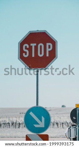 stop sign with a field in the back