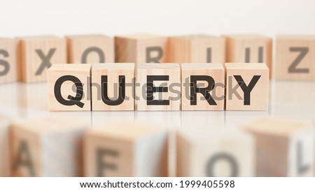 query word from wooden blocks with letters, query or doing business concept, random letters around, white background Royalty-Free Stock Photo #1999405598