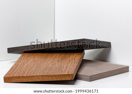 Natural wood texture for design and decor. Samples of wooden facades for kitchen cabinets. Royalty-Free Stock Photo #1999436171
