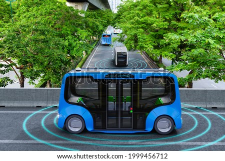 Autonomous electric shuttle bus self driving across city green road, Smart vehicle concept Royalty-Free Stock Photo #1999456712