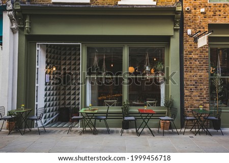 Empty coffee and restaurant terrace with tables and chairs in london indie and hipster style Royalty-Free Stock Photo #1999456718