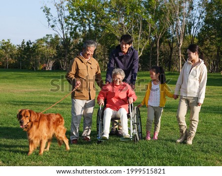 Happy family of five and pet dog walking in the park high quality photo