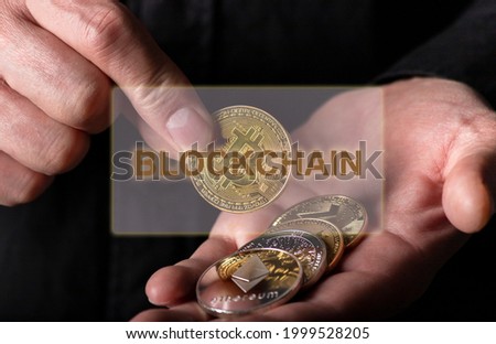 Blockchain word over photo with bitcoin and other cryptocurrency coins.