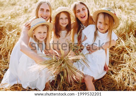Mothers with daughters playing in a autumn field
