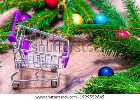 Trolley . Branches of a Christmas tree. Cart . Concept for Christmas shopping.