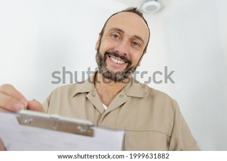 happy builder using a clipboard