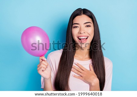 Photo of young cheerful girl happy positive smile amazed surprised party celebration balloon isolated over blue color background