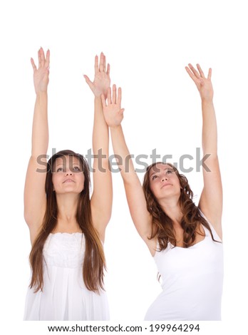 picture of two young happy woman with hands up