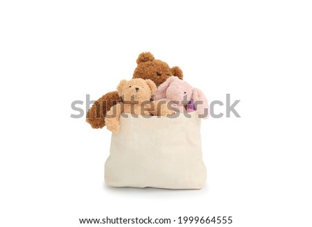 Dolls in a cloth bag for donation isolated on white background. Image with Clipping path