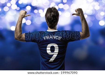French soccer player, celebrating on a blue lights background.