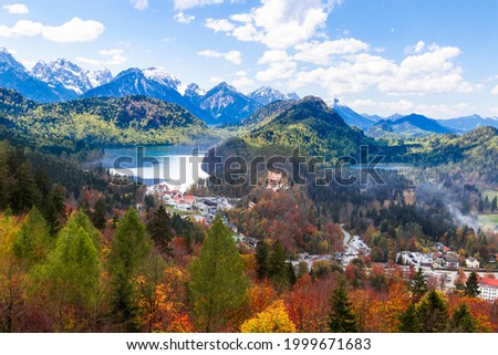 Landscape  of Hohenschwangau Castle, Bavaria, Germany. Beautiful panorama of mountain lakes. Scenery of  Alpine nature in autumn. Aerial scenic view of village in Alps.