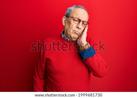 Handsome senior man with grey hair wearing casual clothes and glasses thinking looking tired and bored with depression problems with crossed arms. 