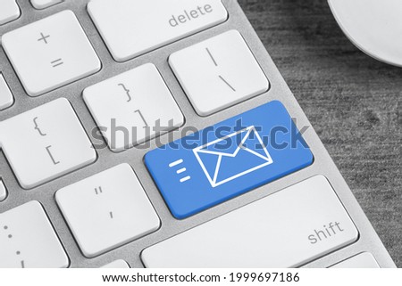 Modern computer keyboard with envelope sign on button, closeup view. Sending email letters