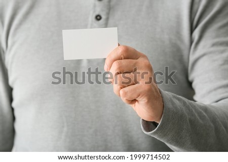 Man with blank business card, closeup