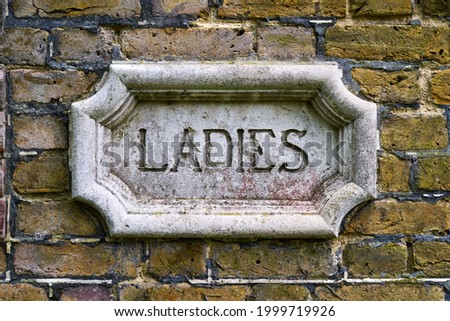 A Victorian Gentlemen sign for the bathroom cast in concrete Royalty-Free Stock Photo #1999719926
