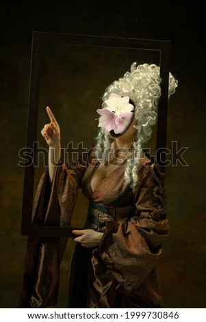 Artwork in frame. Model like medieval royalty person in vintage clothing. Concept of comparison of eras, artwork, renaissance, baroque style. Creative collage. Surrealism