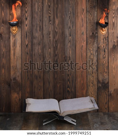 ancient open book on wooden background