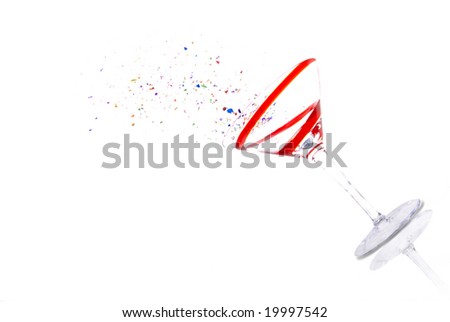 High Key image of red striped martini glass and colorful confetti.