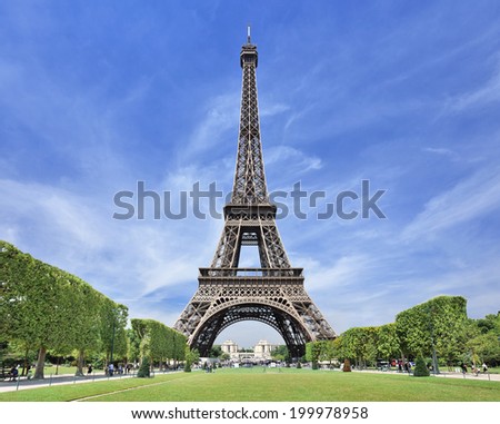 The majestic Eiffel tower in Paris against a blue sky Royalty-Free Stock Photo #199978958