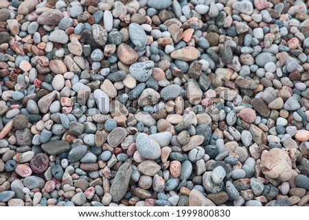 Small beach pebbles, smooth pebbles on the sea beach, Mediterranean sea, background
