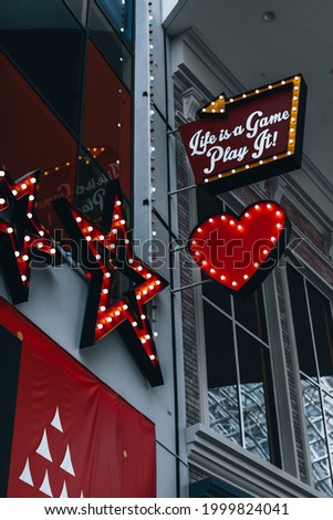 Cafe entrance with glowing red neon heart and stars signs