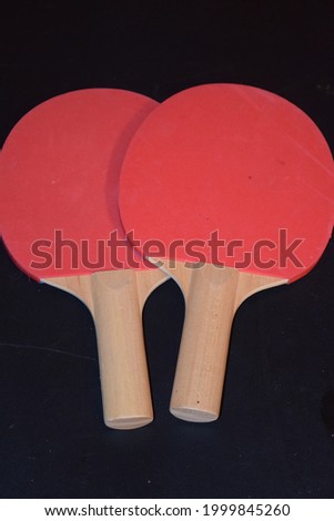 Ping pong paddles with a black background