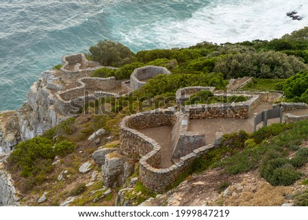 Stones steps going to the the rocks cliffs at the Cape of Good Hope in South Africa. Royalty-Free Stock Photo #1999847219