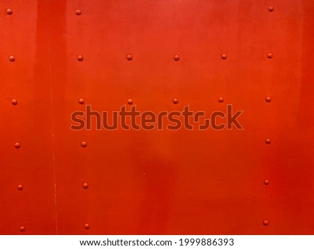 Picture of Rivets in red background .