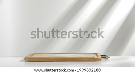 Wooden desk of free space for decoration and wall with shadows 