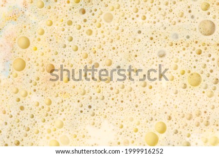 Macro Gold and bronze bubble drops. Abstract flow color blots on light horizontal background.